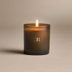 a candle that is lit up with the letter r on it's front and side