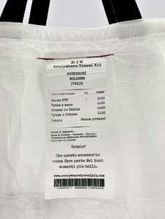 a white bag with a barcode label on the front and back of it's handles