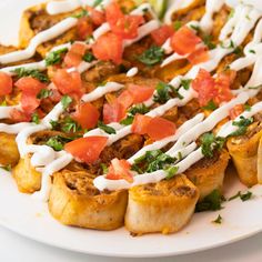 a white plate topped with food covered in sauce and toppings