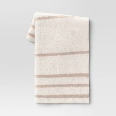 a white and brown striped towel on a gray background