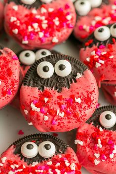 red and white cupcakes decorated with eyes and sprinkles on a plate