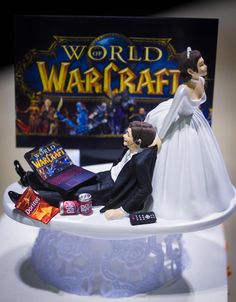 a wedding cake topper with a bride and groom figurine sitting on it