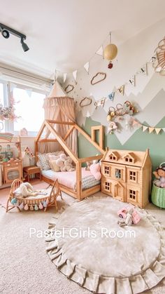 a child's bedroom decorated in pastel colors and wooden furniture, including a doll house