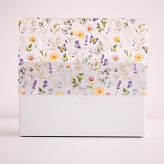 a white box with flowers and butterflies on it