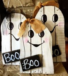 two wooden signs that say boo and one has a bow on it's head