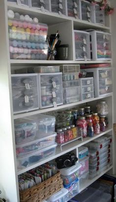 the shelves are filled with craft supplies and other items in baskets, boxes, and bins