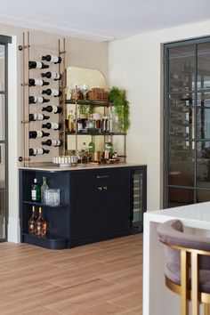 a wine rack in the corner of a room next to a bar with bottles on it