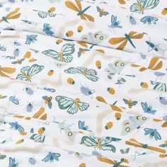 a white sheet with blue and yellow butterflies on it