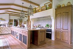 a large kitchen with wooden cabinets and an island