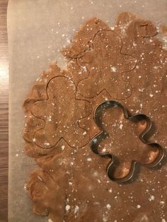 cookie cutters shaped like gingerbread cookies on a baking sheet with powdered sugar