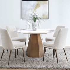 a white table with four chairs around it