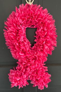 a pink wreath hanging on the front door