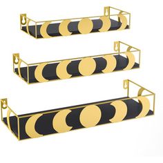 three black and yellow metal shelves with circles on each shelf, one is hanging from the wall