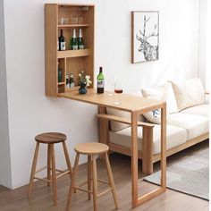 a small table with two stools in front of it and a shelf on the wall