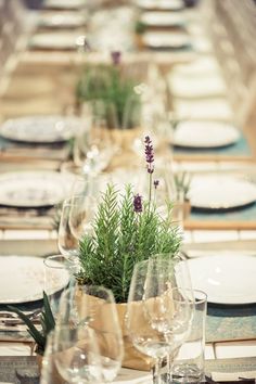 the table is set with place settings, plates and glasses for dinner guests to enjoy