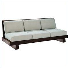 a white and brown couch sitting on top of a wooden frame