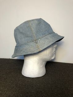 A beautiful denim bucket hat, handmade by myself using a vintage Levi's denim jacket!  It's made from a very heavy duty denim that will last a long time, it could become your favourite hat! It features the iconic 'V' panelling that should make it clear to the average passer by that this was once a denim jacket. It also boasts several areas of faux wear that have been repaired. This was done at the Levi's factory and looks very authentic!  This would make an excellent present for anyone that appr Cheap Trendy Denim Blue Hats, Affordable Denim Bucket Hat With Curved Brim, Cheap Distressed Blue Hat, Cheap Distressed Blue Hats, Vintage Levis Denim Jacket, Denim Bucket Hat, Levis Denim Jacket, Lined Denim Jacket, Summer Beach Party