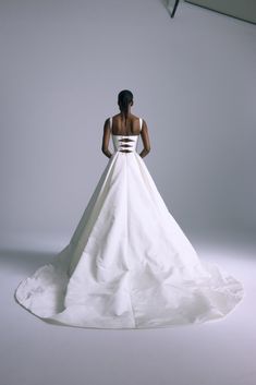 a woman in a white wedding dress looking down