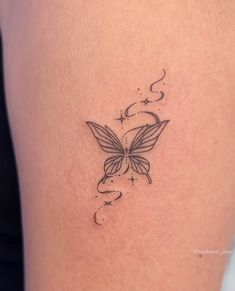 a woman's thigh with a butterfly tattoo on it