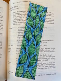 an open book with a blue and green design on it