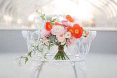 a bouquet of flowers sitting on top of a white chair