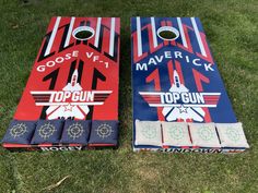 two cornhole game boards laying on the grass