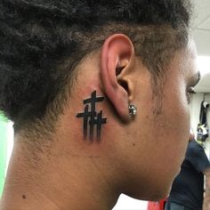 a man with a cross tattoo on his ear