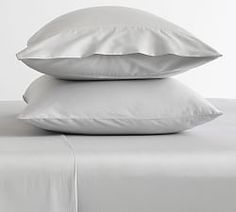 two white pillows are stacked on top of each other