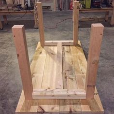 a chair made out of wood sitting on top of a floor