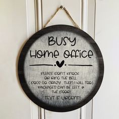 a wooden sign hanging on the side of a door that says, busy home office please don't knock