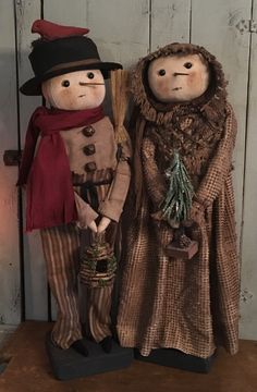 two scarecrows are standing next to each other