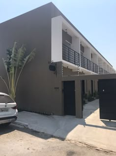 a car parked in front of an apartment building