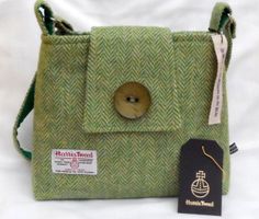 a green bag with a wooden button on it