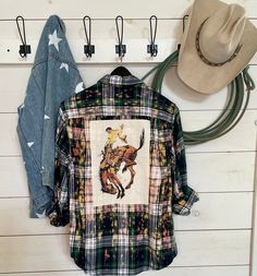 Hand bleached flannel shirt with the bucking horse on the back and Buck name patch sewed on the front, Due to hand bleaching colors may vary. We use a variety of flannel shirts so you may receive a different color than pictured but it will compliment the image. We use men's shirts so they are over sized. Mens Flannel Shirt Refashion, Flannel Upcycle, Flannel Shirt Refashion, Bleach Shirt Diy, Bleached Flannel Shirt, Shirt Makeover, Bleached Flannel, Bucking Horse, Cut Up Shirts