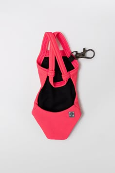 a pink and black purse with a keychain hanging from it's side