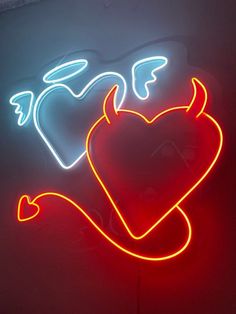 a neon sign with two hearts and an arrow