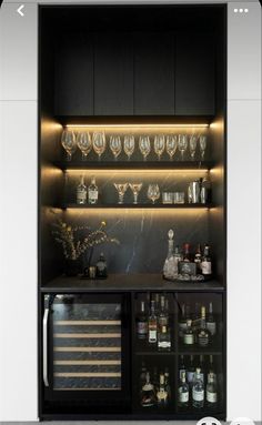 an open cabinet with bottles and glasses on it