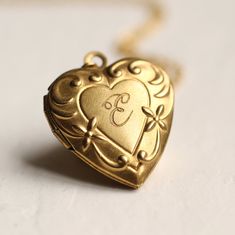 This beautiful vintage locket is a simple heart shape with an ornate Art Nouveau border, the perfect size for either an adult or child. The locket measures only 25mm (one inch) across and is made from solid brass. The size of this pendant means it can be worn by an adult or a child. I make each necklace to order and this necklace is available in a choice of chain lengths. Please refer to my illustration for a guide to how these lengths might look when worn. For girls under ten years, I would rec Initial Locket Necklace, Unique Locket Necklace, Locket Necklace Heart, Vintage Heart Locket, Locket Jewelry, Engraved Locket, Gold Heart Locket