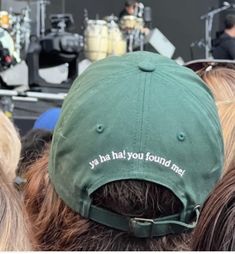 a person wearing a green hat with the words you had you found me written on it