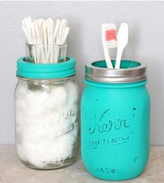 two mason jars with toothbrushes in them