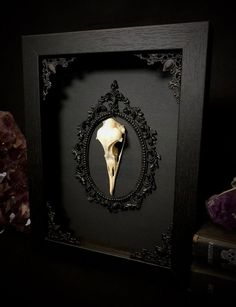 a black frame with a white animal's skull in it