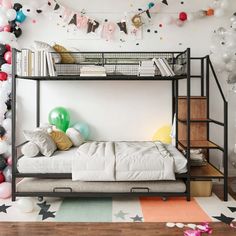 a bunk bed in a room with balloons and streamers on the wall behind it