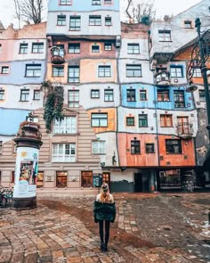 a woman is standing in front of some buildings