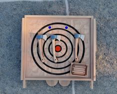 an overhead view of a wooden target with three arrows