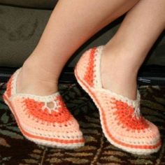 a woman's feet wearing crocheted slippers