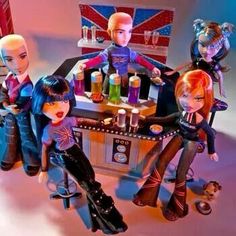 several dolls are sitting at a bar with drinks