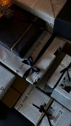 several books wrapped in black paper and tied with ribbon