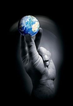 a hand holding up the earth in front of a black background with text that reads art com