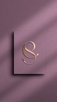 the letter s is inscribed in gold on a purple background