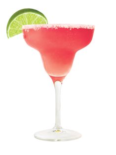 a pink margarita with a lime slice on the rim